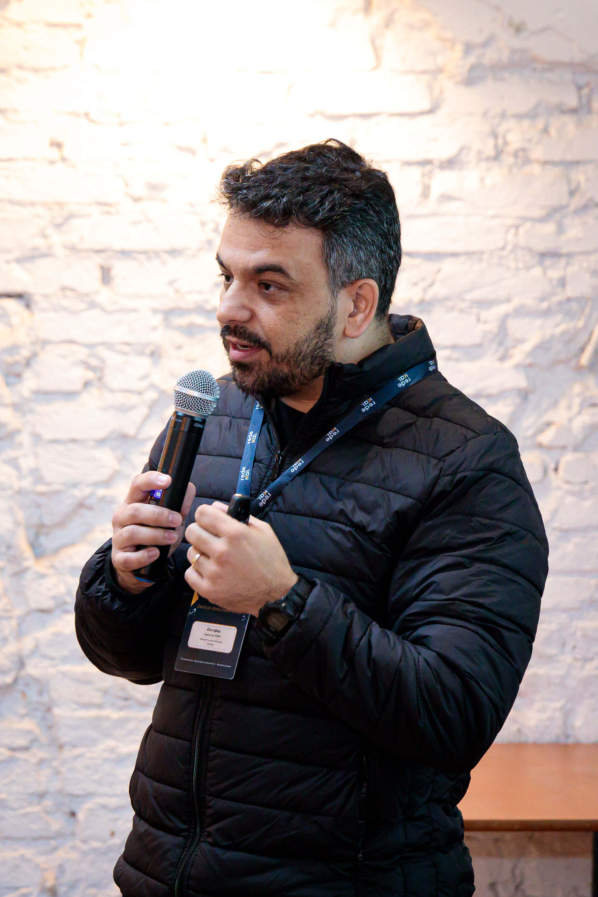 Douglas Oliveira palestrando com microfone